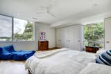 Bedroom, Bed, Dresser, and Light Hardwood Floor  Photo 9 of 12 in A Refined Austin Home With Verdant Views Asks Just Under $2M