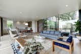 Living Room, Sofa, Chair, Bench, Coffee Tables, Recessed Lighting, and Light Hardwood Floor  Photo 5 of 12 in A Refined Austin Home With Verdant Views Asks Just Under $2M