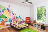 Kids Room, Bedroom Room Type, Bed, Night Stands, Chair, Medium Hardwood Floor, and Pre-Teen Age  Photo 10 of 14 in An Austin Couple Turn a Ranch Home Into a Refreshing Live/Work Space