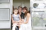 Ellen Prasse, Kate Oliver, and their daughter, Adelaide, in the doorway of a renovated Airstream.