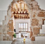 As if undertaking an archaeological dig, architect Carles Oliver peels back layers of his home over the course of three years. Cities that are inundated by tourists, such as Palma de Mallorca, Spain, can suffer severe housing shortages that call for the reappropriation of unused space. Architect Carles Oliver undertook just this task, rehabbing an old, empty building with a budget of just over $21,000. Through an urban sharecropping contract, the work on the home was done in exchange for three years of rent.