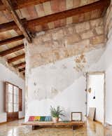 Architect Carles Oliver rehabbed an old, empty building in the Spanish city of Palma over the course of three years. While the majority of the $21,000 budget went toward improving the home’s energy efficiency, the rest was spent on removing layers of architecture to reveal the original construction, including the stone-clad walls and wooden ceilings.