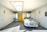 Garage Entry through the skylit carport gives way to the classic mid-century yellow door, complete with original hardware.  Photo 14 of 14 in A Midcentury-Modern Home in L.A. Designed by Richard Banta Is For Sale For $899K