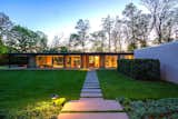 Outdoor, Front Yard, Trees, Grass, Walkways, and Landscape Lighting  Search “landscapes--walkways” from A Renovated, Midcentury Glass-and-Steel House in New York Asks $2M