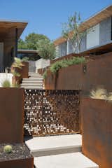 Outdoor, Metal Fences, Wall, and Walkways The motif is expressed in weathered steel for a gate.
-
Austin, Texas
Dwell Magazine : November / December 2017  Photo 3 of 7 in Besides Being Works of Art, These Custom Metal Shutters Master the Texas Heat