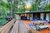 Outdoor, Decking Patio, Porch, Deck, Wood Patio, Porch, Deck, Wood Fences, Wall, Woodland, Trees, Horizontal Fences, Wall, and Concrete Patio, Porch, Deck  Photo 4 of 11 in Live Out Frank Lloyd Wright’s Usonian Vision in This Home That’s Asking $725K