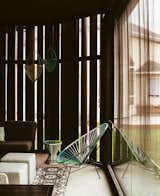 A veil of Cor-Ten steel and a motorized blind from Phantom Screens filter sunlight on the screened porch. The Acapulco chair and Sonny Hanging planters are from CB2.

East St. Paul, Manitoba
Dwell Magazine : November / December 2017