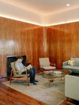 In the living room, more zebrawood paneling is accented by LED strips.