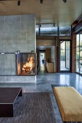 Living, Corner, Wood Burning, Concrete, Bench, and Rug Inspired by Russian and Finnish designs, the fireplace harvests hot air by sending it into the basement and radiating it into the room.
-
Tehachapi Mountains, California
Dwell Magazine : November / December 2017  Living Bench Corner Concrete Photos from At This High-Desert Home, a Whole Wall Opens Up When You Crank a Giant Wheel