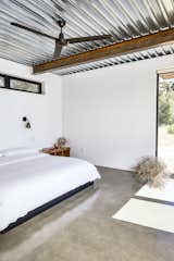 Bedroom, Bed, Concrete Floor, Wall Lighting, and Night Stands The master bedroom occupies one of three units extending off the main space. Like other furnishings, the bed was made by steel fabricators.
-
Tehachapi Mountains, California
Dwell Magazine : November / December 2017  Photo 2 of 7 in CEILINGS by Maria Danielides from At This High-Desert Home, a Whole Wall Opens Up When You Crank a Giant Wheel
