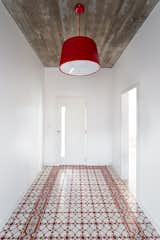 Hallway and Ceramic Tile Floor A red Cloche pendant by Newline complements the Fabrica de Mosaicos tile in the entryway.
-
Pato Branco, Brazil
Dwell Magazine : November / December 2017  Photo 3 of 5 in A Brazilian Architect Builds a Dream Home for Her Parents