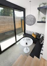 In the breakfast nook, an Ikea table is surrounded by a bench made specifically for the corner by CJS Custom Woodworking &amp; Design. A Moooi pendant light and custom concrete floors distinguish the area.&nbsp;