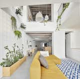 Living, Concrete, Pendant, Rug, Sectional, and Storage  Living Rug Concrete Sectional Pendant Photos from Can This Renovated, Loft-Like Home in Spain Be Any Dreamier?
