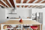 Kitchen, Microwave, Refrigerator, Wall Oven, Undermount, Range, Range Hood, White, Concrete, and Pendant  Kitchen Concrete Undermount Refrigerator White Range Hood Microwave Photos from Can This Renovated, Loft-Like Home in Spain Be Any Dreamier?