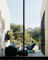 The east patio overlooks to the yaupon holly trees.