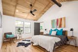 Bedroom, Medium Hardwood Floor, Lamps, Bed, Night Stands, Chair, Ceiling Lighting, and Recessed Lighting  Photo 7 of 13 in In Arizona, a Modern Cube and Tumbledown 1930s Shack Make an Unlikely Couple