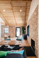 Living Room, Coffee Tables, Recessed Lighting, Standard Layout Fireplace, Ceiling Lighting, Sofa, Chair, and Medium Hardwood Floor  Photo 11 of 13 in In Arizona, a Modern Cube and Tumbledown 1930s Shack Make an Unlikely Couple