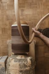 Sand: A balloon sander ﬁtted with 60-grit sandpaper smooths off the rasp marks, then the team uses 220-grit sandpaper to hand-sand the arm to a ﬁnal ﬁnish.  Photo 15 of 19 in Watch: It Takes Nine Hours For Woodworkers to Make This Shaker-Inspired Chair