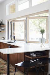 A 14-foot-wide opening defines the kitchen, which architect Scott Delano, with Nicholas Pettit, carved out of what had been an enclosed breezeway and part of the garage. The bifold window is from NanaWall, the windows above are by Pella, and  the faucet is by Blanco.