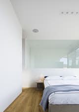 Bedroom, Bed, Table Lighting, Recessed Lighting, Light Hardwood Floor, and Night Stands  Photo 13 of 15 in Cut-Out House by Dwell from After a Renovation, a Classic San Francisco Victorian Is Now Bursting With Light and Color