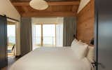 Timber cover master bedroom featuring king sized bed and ocean views.