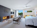 Bedroom, Bed, Chair, Carpet Floor, and Accent Lighting  Photo 7 of 12 in Midcentury Modern Meets The Mountain by Dwell