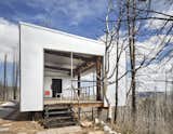 Except for a few chairs and a wood stove, there isn't much to Eric Logan's two-room cabin in the forest of Wyoming's Casper Mountain. After the original antiques-filled family cabin was destroyed in a brush fire, Logan, principal at Carney Logan Burke Architects, built this minimalist iteration to reinforce the importance of one's relationship with nature, magnified by the post-and-beam structure comprised of charred trees.&nbsp;