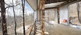 Outdoor, Wood Patio, Porch, Deck, and Trees The Phoenix is what owner and architect Eric Logan describes as a cool little folly in the woods.  Photo 3 of 12 in An Architect’s Cabin Rises From the Ashes After a Devastating Forest Fire