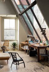 Office, Lamps, Painted Wood Floor, Craft Room Room Type, Desk, and Chair Located in a historic building in Westerly, Rhode Island, Spellman's studio is infused with natural light, thanks to the expansive windows.  Photos from This Stunning Studio in Rhode Island Is a Creative’s Dream