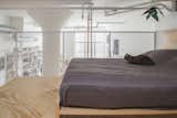 Bedroom, Light Hardwood Floor, and Bed The loft’s four-foot-high rail was fabricated by general contractor Create NYC Contracting, using metal mesh from McNichols. The bed is by Nathaniel Wojtalik.  Photo 6 of 7 in This Brooklyn Fashion Designer’s Cozy Loft Was Renovated on a Budget