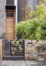 Exterior, Concrete Siding Material, Wood Siding Material, House Building Type, and Stone Siding Material The gate leading to Geoff Carroll and Julie Young’s rebuilt terrace house in an inner suburb of Sydney, Australia, holds an array of succulents, signaling what lies within:  a greenery-filled home that includes a central courtyard, vertical gardens, aquaponics and rain filter systems, and even a chicken coop. Architect Clinton Cole of CplusC Architectural Workshop led a team of collaborators in revamping the property.  Photos from A Sustainable Home Near Sydney Boasts Chicken Coops, Vertical Gardens, and More