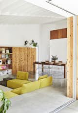 In the living area, a cedar storage unit made by Grant features a five-by-five-foot sliding panel that conceals shelving and the television. “It’s a way to make it feel less like a TV room during the day,” Beer says. The sunken sofa—a throwback to the residents’ childhoods in the 1970s— is from the Houdini collection by King Living. The dining chairs were a secondhand purchase.
