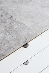 <b>Kitchen Countertops: </b>The Jacks saved about $6,500 by skipping counter-sized marble  slabs and using one-by-two-foot marble tiles, sealed with silicone. “The counters are thin and highly polished, but the sides have a rough texture,” Beer observes.