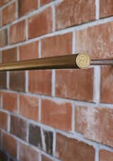 <b>Door Pulls &amp; Lights:</b> Grant made many of the light fixtures and door pulls himself using brass tubing. For the lights, he realized that a New Zealand dollar coin was the perfect size for the end caps, a discovery that saved him $36 on store-bought versions.