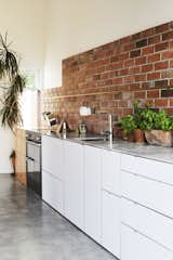 Kitchen, White, Brick, Wall Oven, Concrete, Undermount, and Marble  Kitchen Undermount Wall Oven Marble Brick White Photos from This DIY Home in New Zealand Doubles as a Coffee Spot and Art Gallery