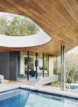 A second aperture in the roof is located over the shallow end of the pool. An alfresco dining area, with seating by Kettal, is perched a few steps below.