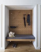 New storage, multifunctional pegs, and pegboards help a New York City lawyer make the most of his 710-square-foot apartment. In the foyer, StudioKCA turned a closet into a valet area.&nbsp;