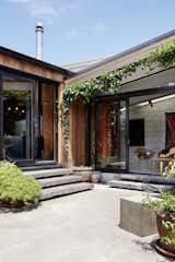 Outdoor, Concrete Patio, Porch, Deck, and Planters Patio, Porch, Deck Ample greenery in the courtyards softens the neutral material palette.  Photo 6 of 19 in This New Zealand Architect Created a House That Looks Like a Tiny Village
