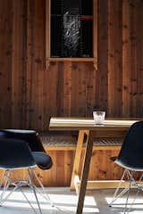 The wood paneling in the dining area and the artwork by her father evoke the villa Andrea Hotere grew up in.