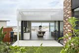 Outdoor, Grass, Side Yard, and Small Patio, Porch, Deck The home's sci-fi structure seems to hover over the landscape.  Photo 5 of 8 in 1 by JP Colantuono from A Futuristic Abode in Australia Draws Inspiration From Star Wars