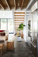 Kitchen, Wall Oven, Ceiling Lighting, Concrete Floor, and Refrigerator The appliances are by Sub-Zero Wolf.  Photo 3 of 17 in Explore the Japanese-Style Home of Two L.A. Tastemakers