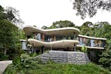 Exterior, Glass Siding Material, House Building Type, Green Roof Material, Flat RoofLine, and Concrete Siding Material  Photos from A Funky, Curvaceous Rainforest Home in Australia Hits the Market