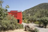 Exterior, Saltbox RoofLine, House Building Type, Metal Siding Material, Prefab Building Type, and Metal Roof Material  Photo 1 of 14 in This Modular Home in Chile Has Us Seeing Red—in a Good Way