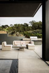 Outdoor, Large Patio, Porch, Deck, Concrete Patio, Porch, Deck, and Concrete Fences, Wall The patio furniture  is from CB2.  Photos from Five Shipping Containers Are Woven Into This Home in Santa Barbara