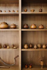 Walnut shelving showcases an extensive collection of treens by 19th-century Ohio woodworker David Mills Pease.
