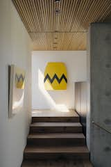 Staircase and Wood Tread “Middle Aged Charlie Brown” by David Buckingham hangs at the top of the staircase.  Photo 1 of 121 in Walls by Leslie Hendry from A Modernist Dream House Makes the Most of a Rare Double Lot in Palo Alto