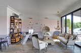 Living Room, Shelves, Wall Lighting, Medium Hardwood Floor, Chair, Pendant Lighting, Desk, and Sofa  Photo 3 of 15 in The Montauk Beach House by Dwell