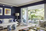 Living Room, Chair, Floor Lighting, and Sofa Wong and Johnson feel their Palm Beach apartment is a reflection of both their personalities. The couple love the navy blue of color of the living room and say it relaxes them.  Photo 4 of 10 in Esteemed Landscape Designer Fernando Wong’s Ocean-Adjacent Retreat in Palm Beach