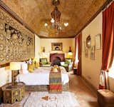 Bedroom, Bed, Ceiling Lighting, Table Lighting, Night Stands, and Rug Floor  Photo 9 of 12 in Kasbah Tamadot by Dwell