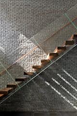 Duratherm windows paint the black brick wall of the staircase with sunlight.&nbsp;